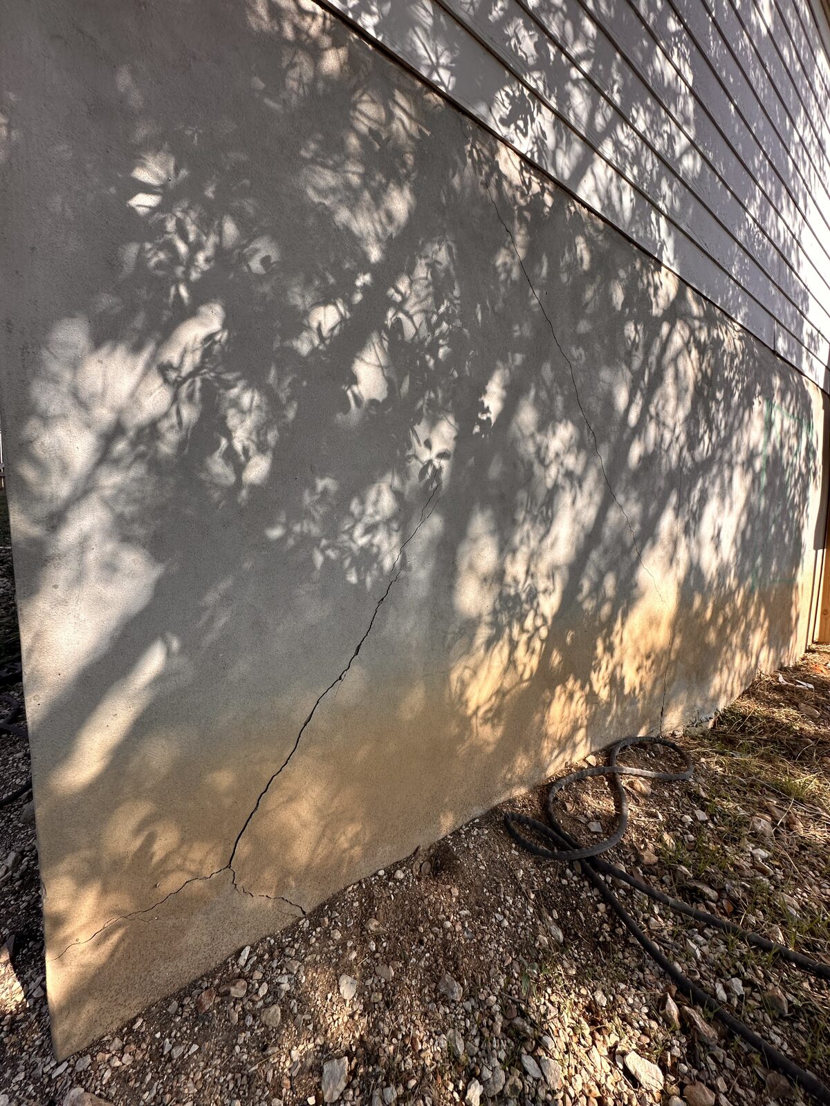 Crack in a shaded concrete stem wall near grade, found during a foundation inspection