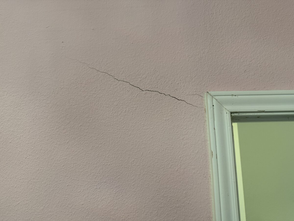 Diagonal crack from an interior door frame corner caused by foundation settlement