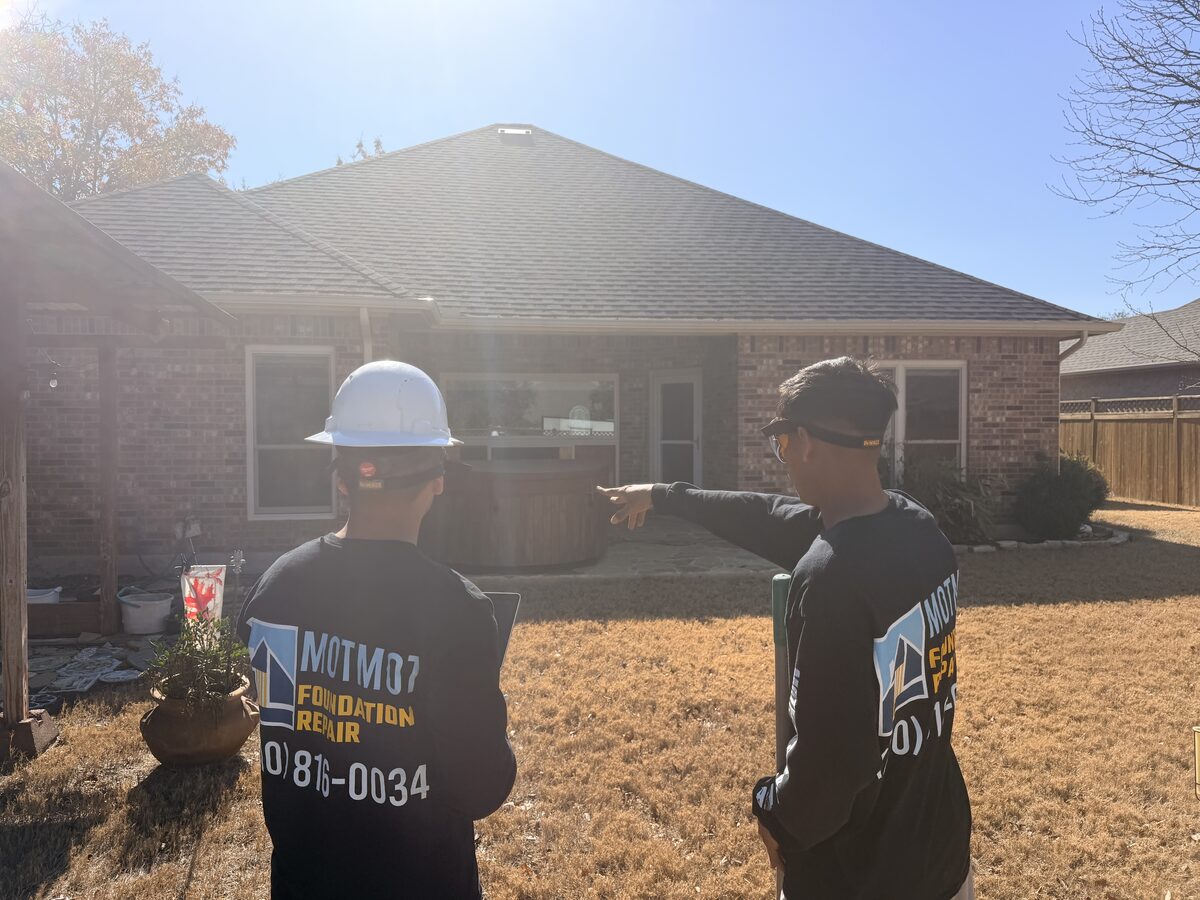 Motmot Foundation Repair crew assessing a single-story brick home before foundation work