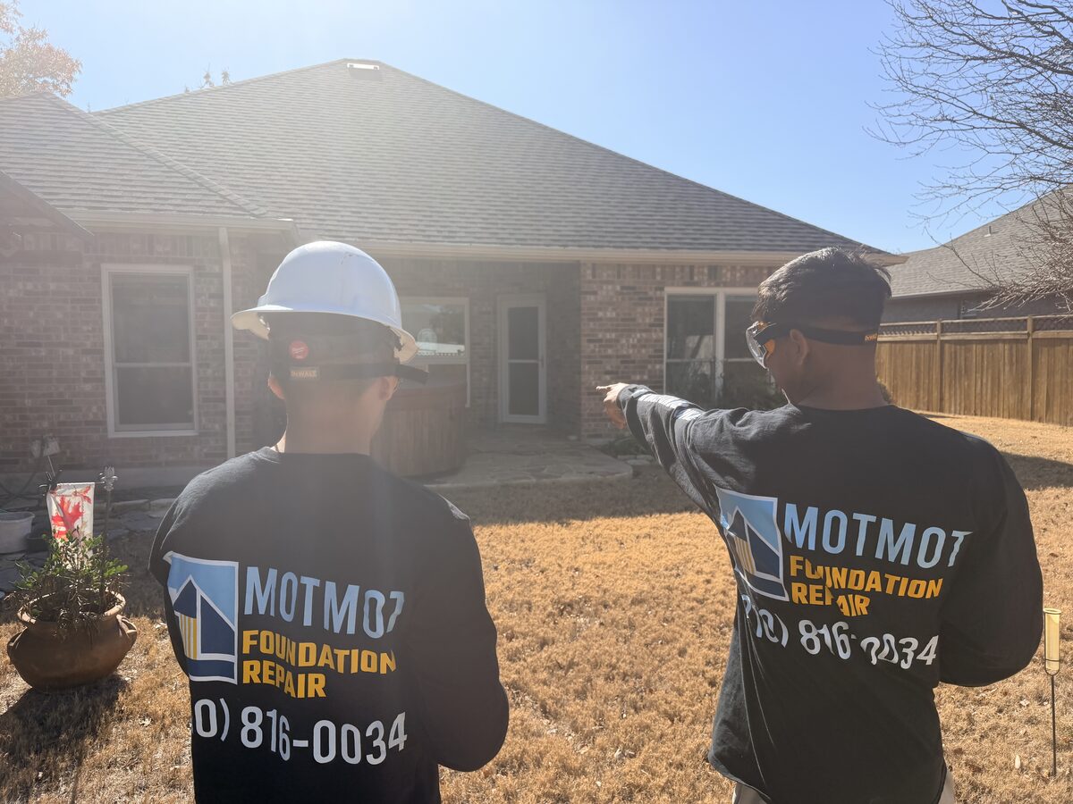 Motmot crew reviewing a building exterior before foundation work begins