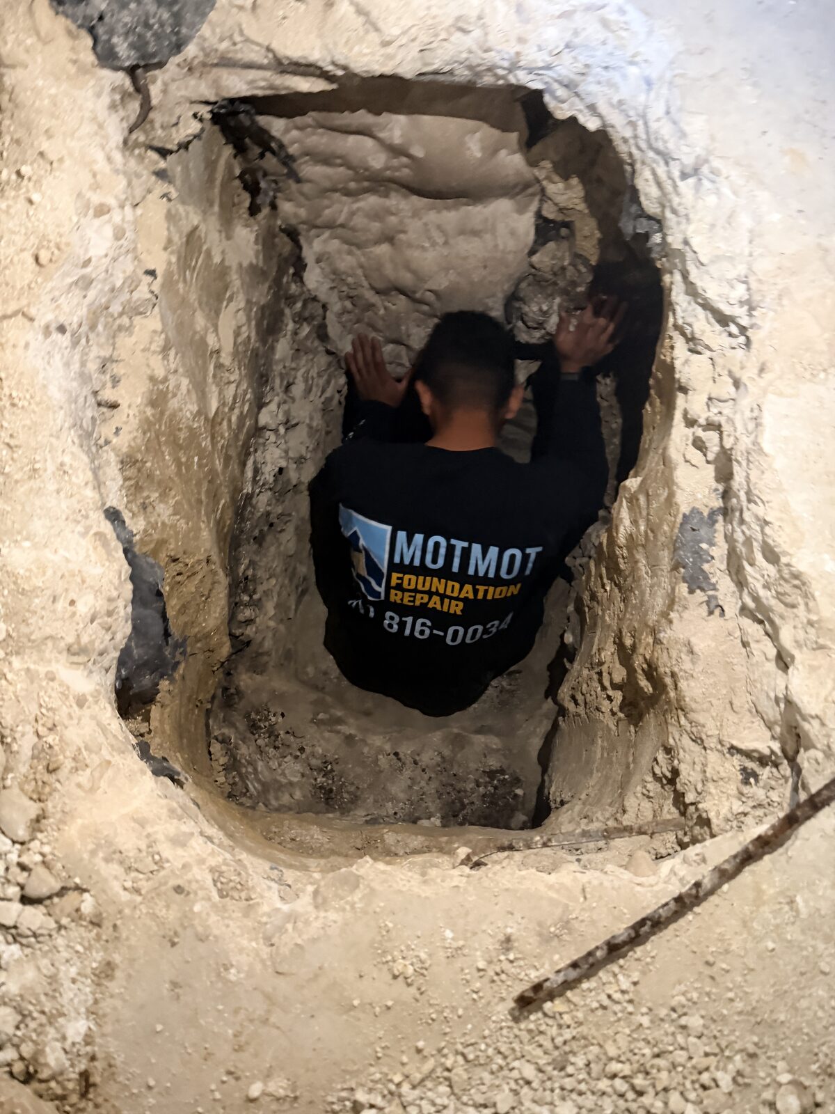 Crew working in a deep foundation pit during a pier installation