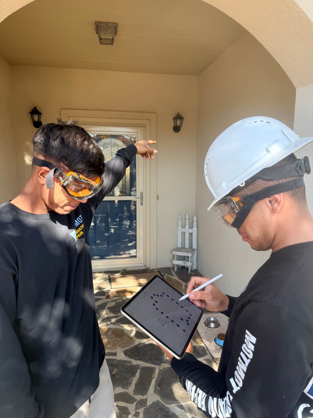 Motmot crew inspecting the foundation perimeter of a brick home in San Antonio