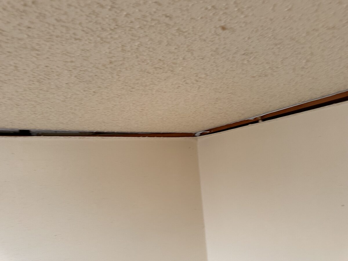 Open gap along the ceiling junction trim caused by long-term foundation settlement