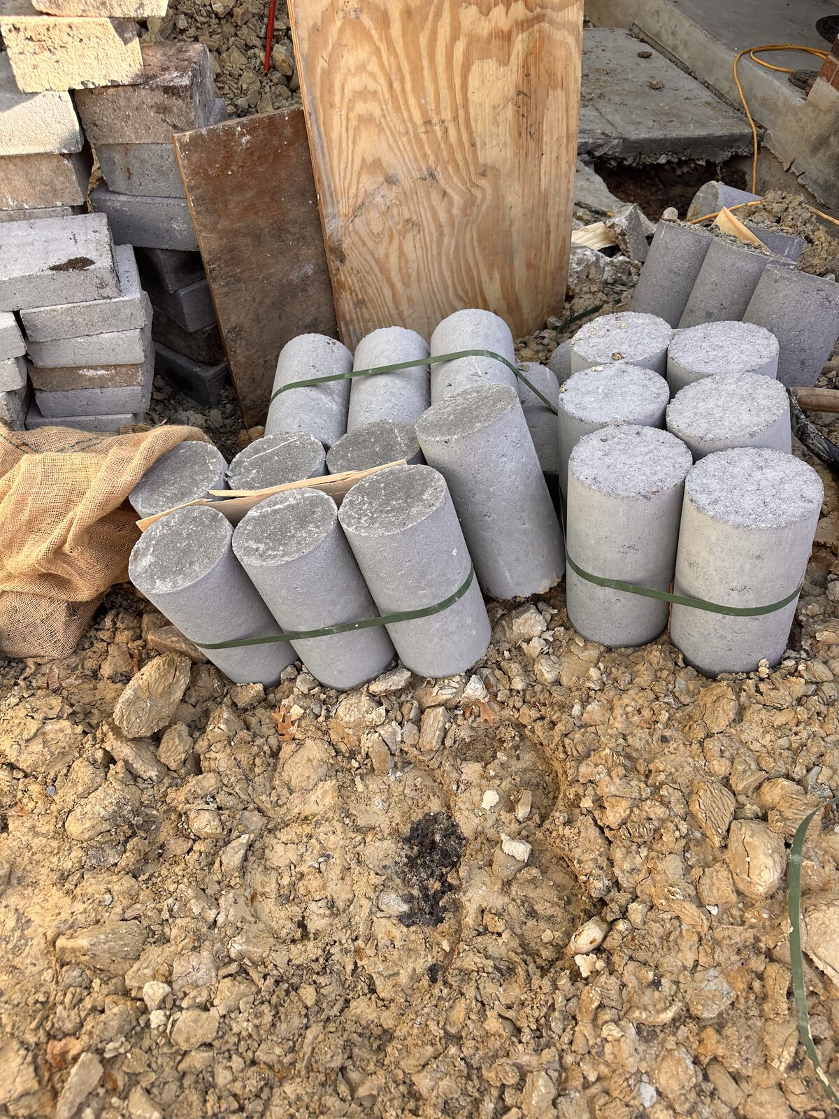 Precast concrete piling segments stacked and staged for foundation pier installation