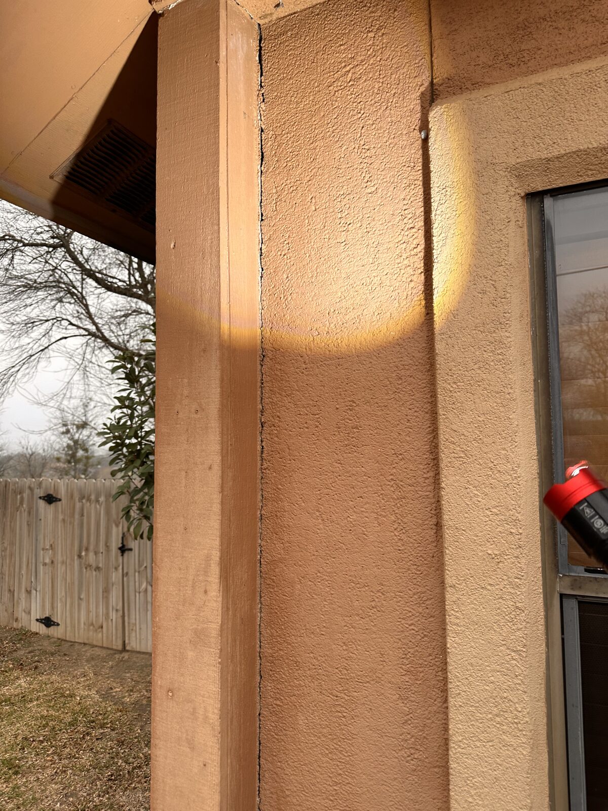 Separating trim at an exterior door jamb, a symptom of foundation settlement around the opening
