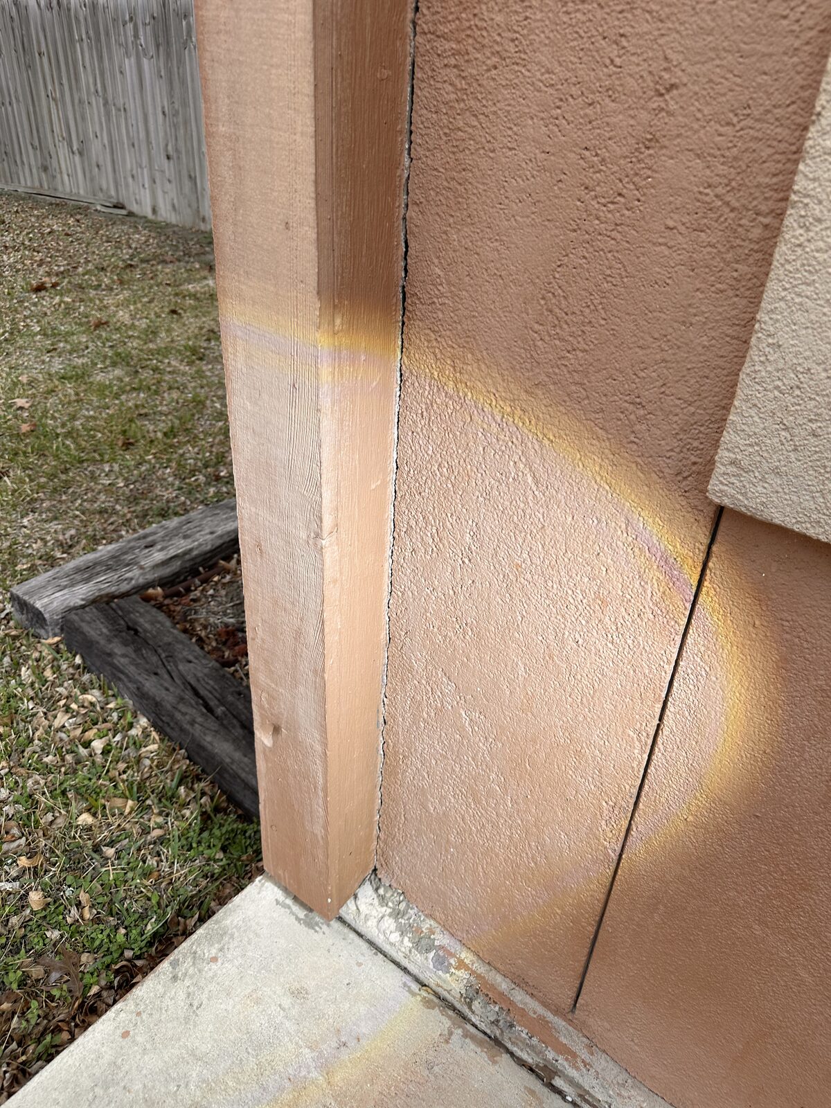 Trim separating at the base of an exterior door where it meets the slab, noted during a foundation evaluation