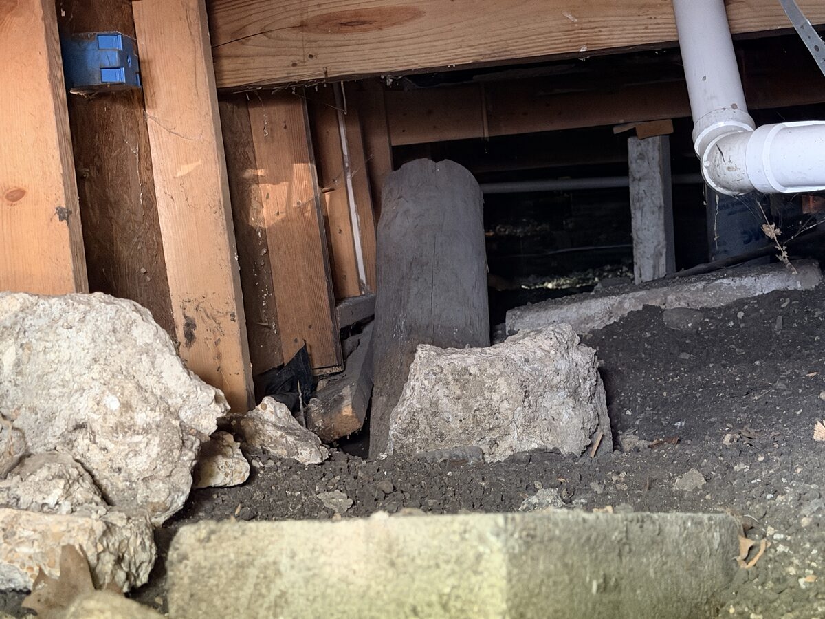 Cracked and spalling concrete at a perimeter beam above a post