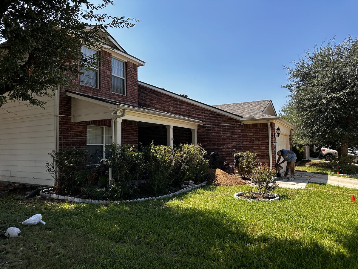 Front of a two-story Central Texas home with restored lawn after foundation repair was completed