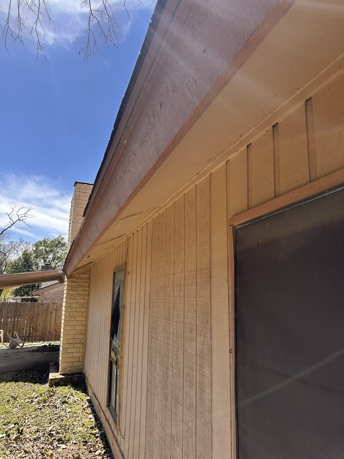 Wood siding and eave line of an older Central Texas home on a pier and beam foundation