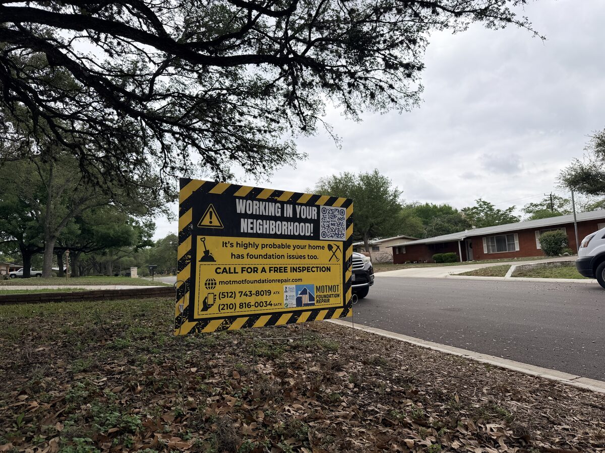 Motmot Foundation Repair yard sign at the curb of a neighborhood home after a completed job