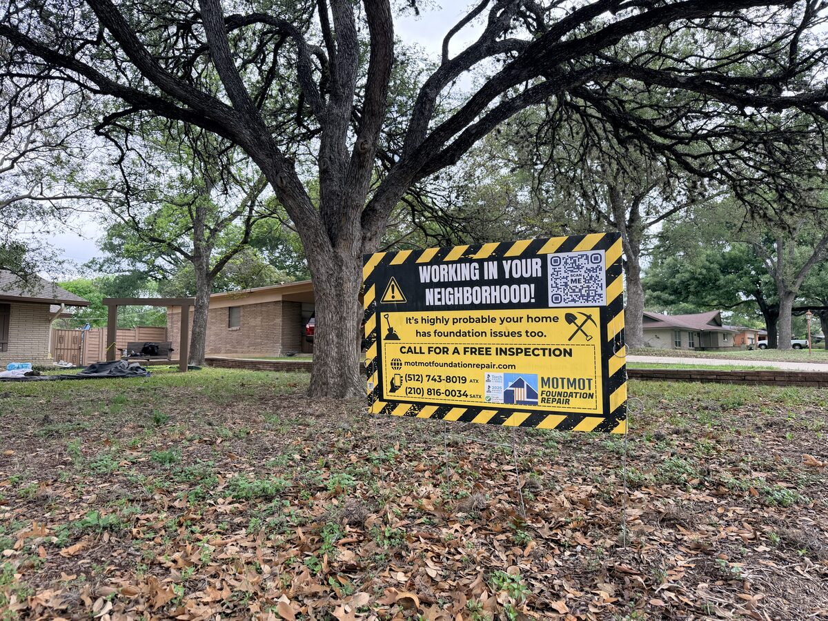 Motmot Foundation Repair 'Working in Your Neighborhood' yard sign posted at an active job site