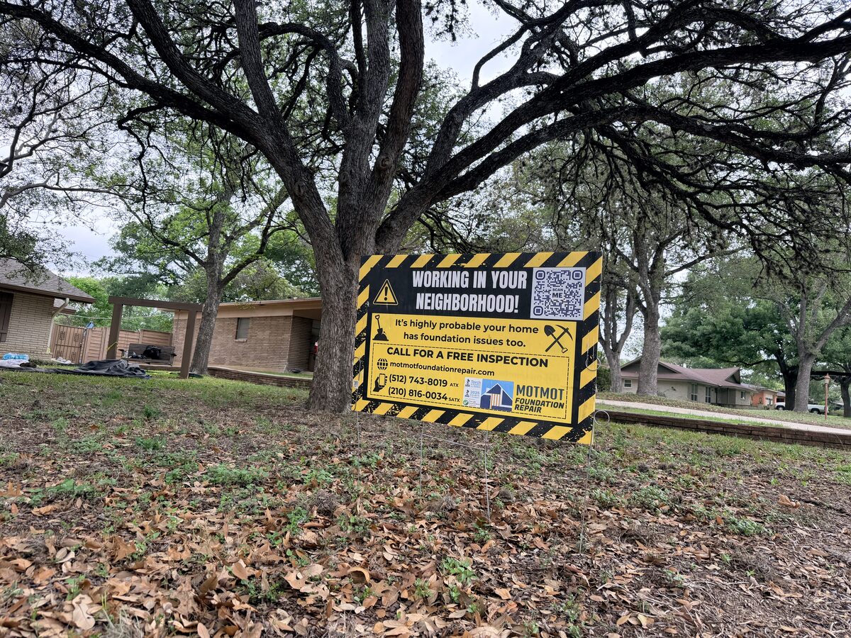 Motmot Foundation Repair yard sign announcing foundation work in a San Antonio neighborhood front yard